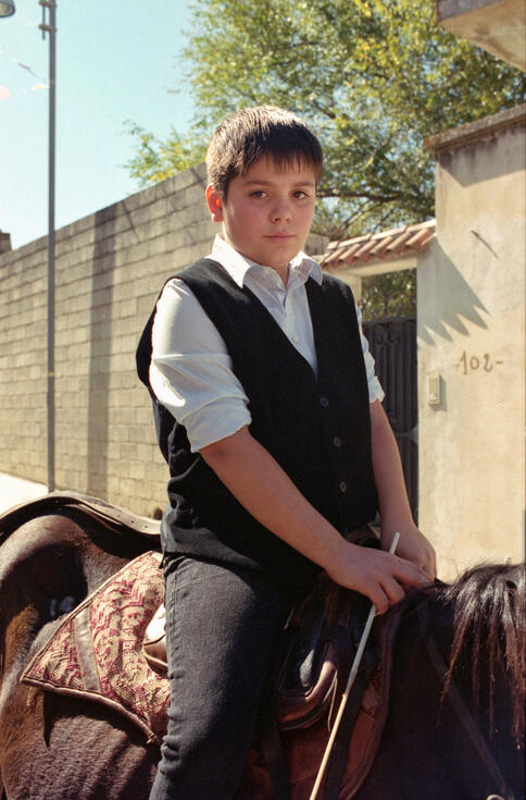 Boy on horseback in traditional dress at a Sardinian festival