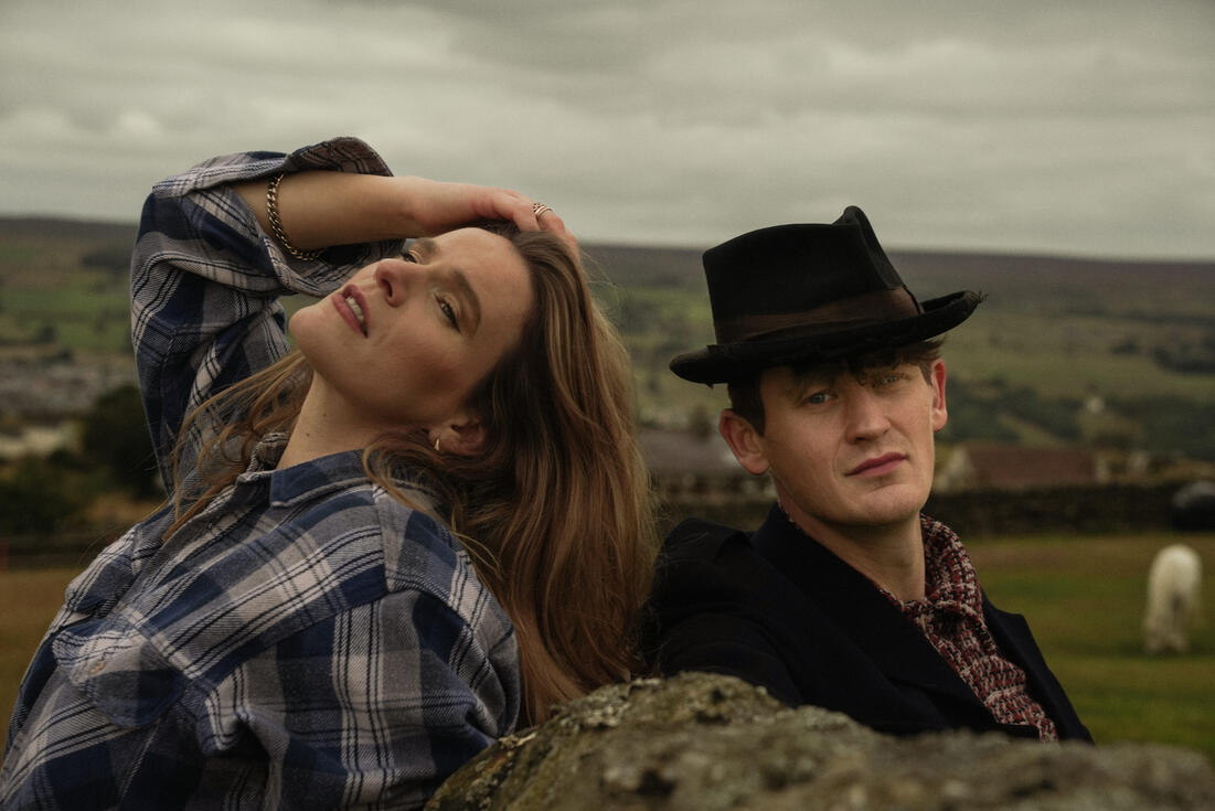The Homburgs reclining outdoors in wide-brimmed hats