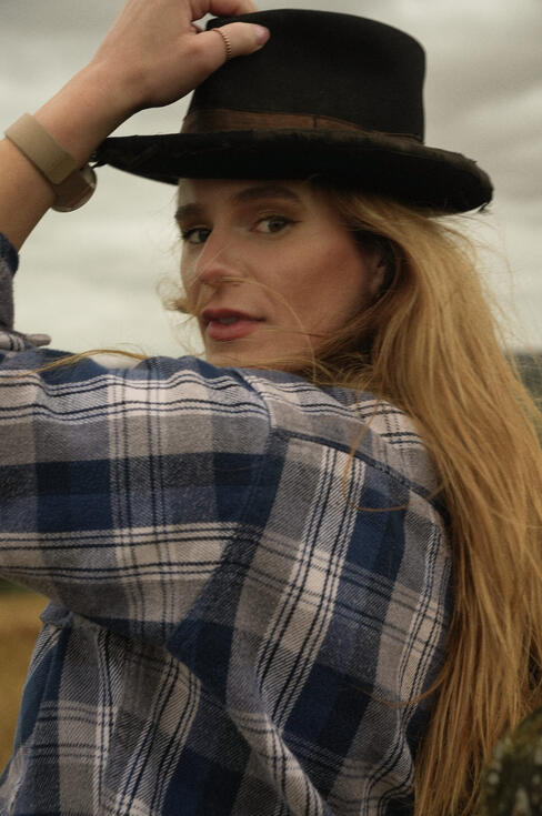 Honey Rhodes of The Homburgs in a plaid shirt outdoors