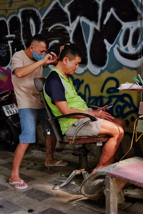 Roadside barber, Hanoi