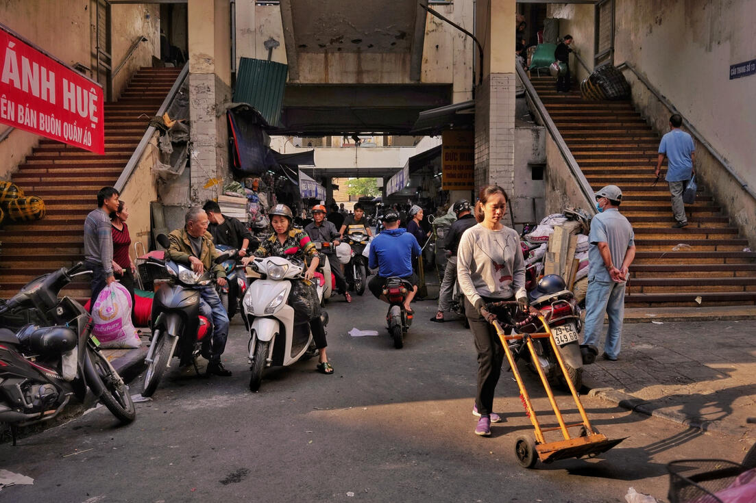 Porter with a hand truck at Dong Xuan market's loading bay, Hanoi