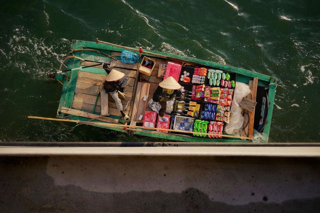 Aerial view of a floating shop boat laden with goods, Halong Bay